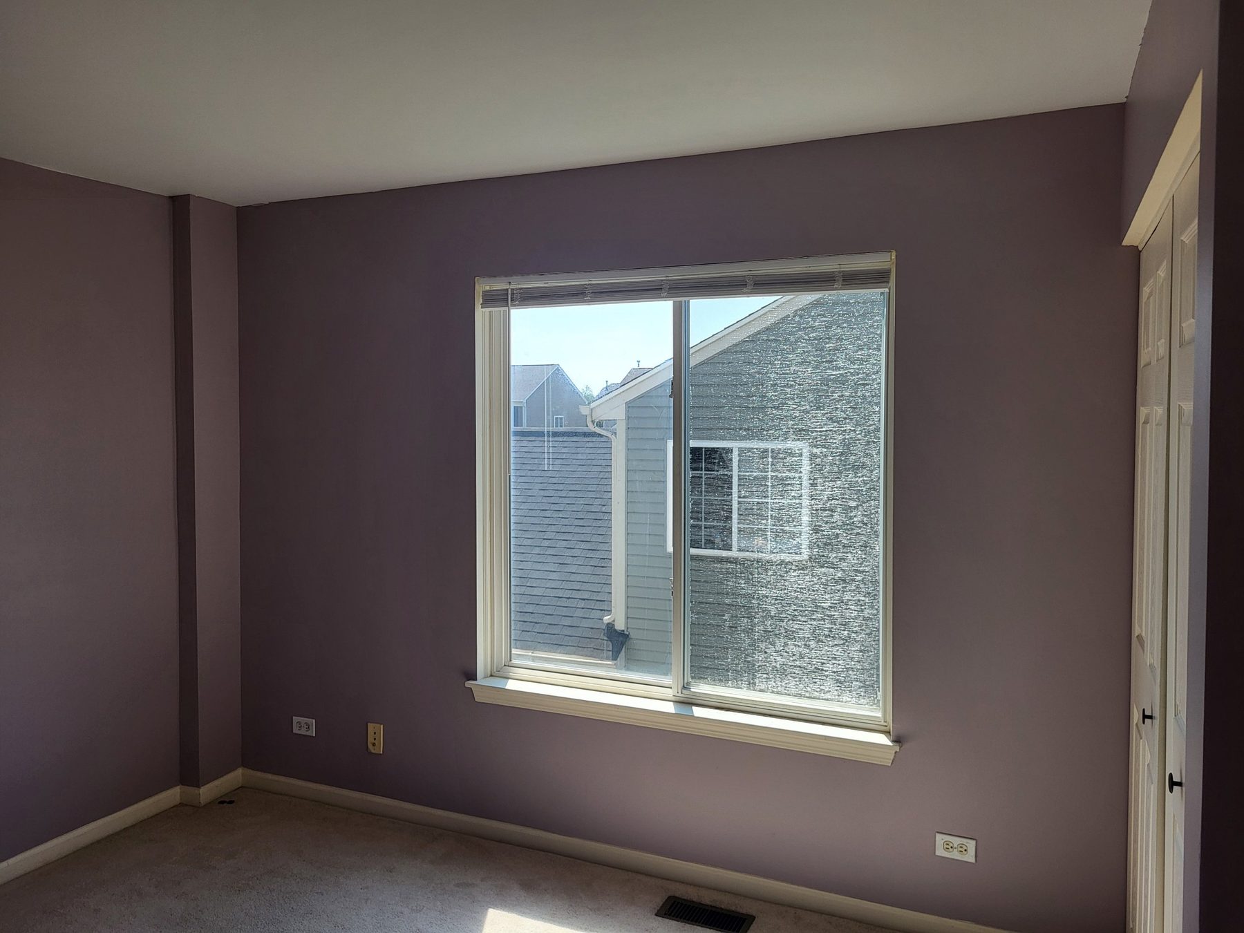 Third bedroom with a large window and closet.