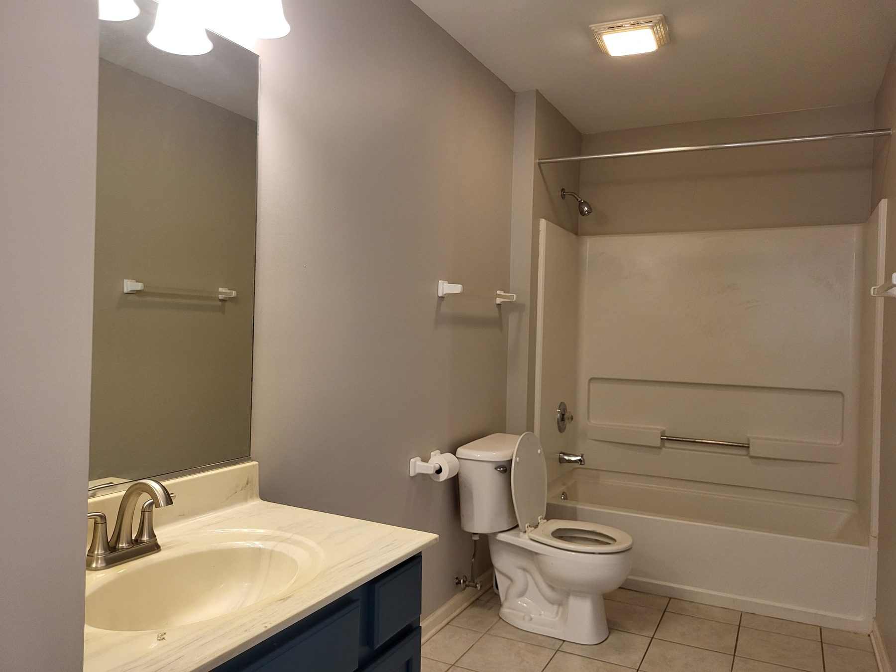 Second full bath with vanity, tile floor and a tub-shower combination.